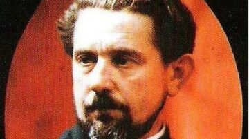 صورة تاريخية لرجل ذو لحية وشعر بني، يظهر بتعبير جاد على وجهه. الخلفية ذات لون دافئ يبرز ملامح الوجه.