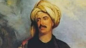 رجل يرتدي عمامة تقليدية، يظهر بتعبير واثق. الخلفية تحتوي على ألوان دافئة، مما يضيف عمقًا للصورة. تعكس الصورة نمطًا تاريخيًا وثقافيًا مميزًا.