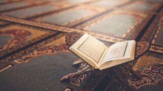Quran open on stand near mosque floor