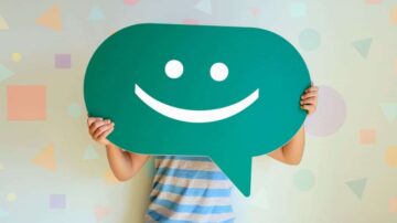 A boy hold a happy face emoji