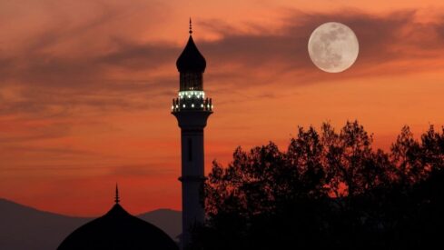 Mosque at dusk with full moon