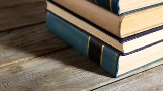 Pile of Books on Wooden Table