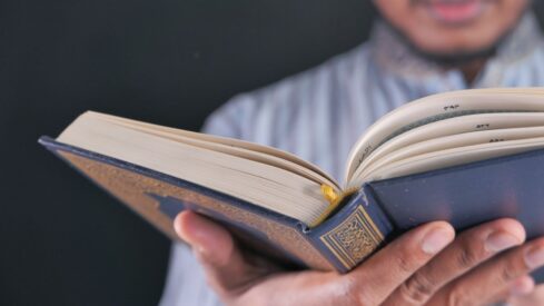 Muslim Mans Hand Reading Quran