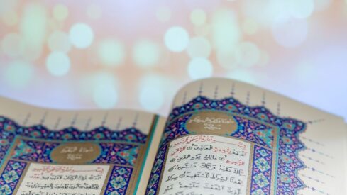 Opening pages of holy book Qur'an with lights