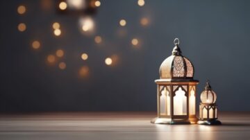 Decorative lanterns with intricate designs and warm light glow on a wooden surface, creating a cozy ambiance. Soft bokeh lights in the background enhance the tranquil atmosphere, ideal for setting a peaceful mood.