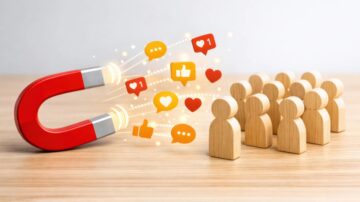 مغناطيس أحمر يجذب رموز التفاعل والأفكار نحو مجموعة خشبية مترابطة، يرمز إلى قوة العلاقات الاجتماعية وفاعلية الأفكار في المجتمع.