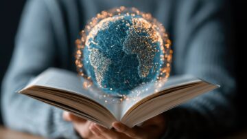 كتاب مفتوح في يد شخص، مع كرة أرضية ثلاثية الأبعاد مضيئة فوق الصفحات، تمثل تكنولوجيا المعلومات والاتصالات.